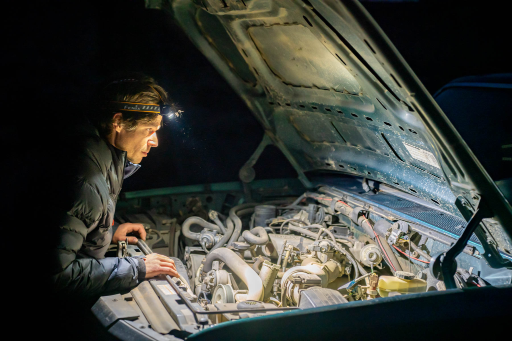 You need to repair your car in a dimly lit parking garage using only the light from your headlamp.