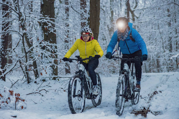 Riding a bicycle in the snow while wearing a headlamp