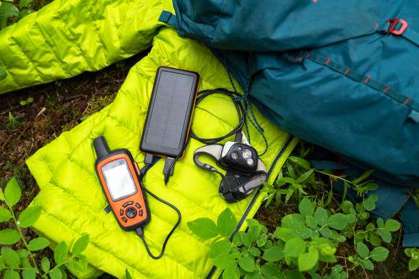 Camping gear including GPS, solar charger, and headlamp.