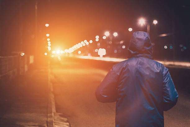 Night runner on a dark street; a powerful headlamp improves visibility and safety.