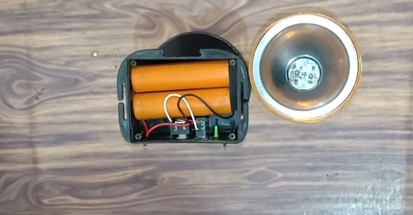 Headlamp components showing batteries, circuit board, and LED.